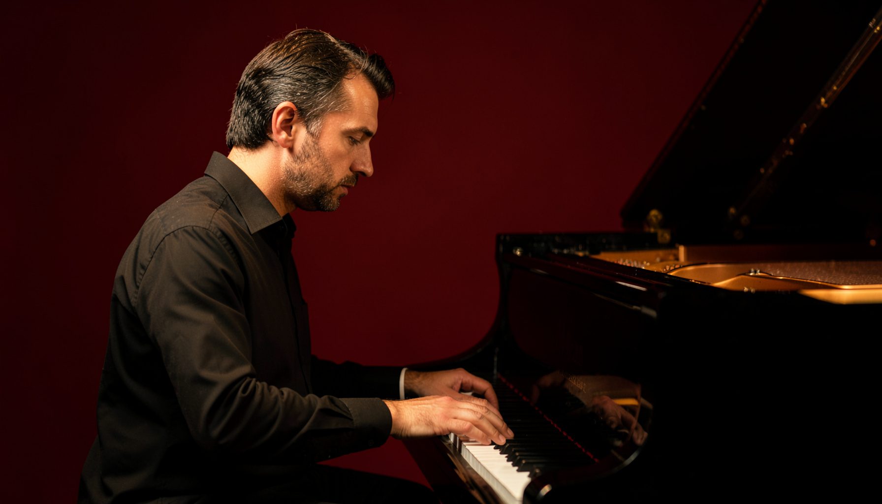 A pianist seated at a grand piano, hands resting on the keys, warm amber lighting and a contemplative mood